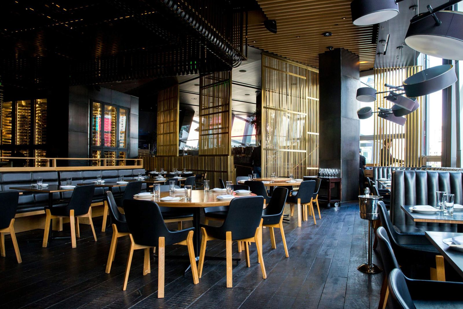 The dining room with round tables and leather booths